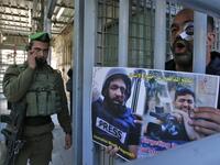 A Palestinian demonstrator takes part in a demonstration in support of Muath Amarneh, a photographer who was hit in the eye last week during clashes between Israeli border police and Palestinian demonstrators in the village of Surif, in front an Israeli checkpoint in the divided Palestinian city of Hebron on November 18, 2019. HAZEM BADER / AFP