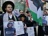 Palestinian demonstrators and religious Jewish men belonging to Neturei Karta, a small faction of anti-Zionist ultra-Orthodox Jews who oppose Israel's existence, take part in a demonstration in support of Muath Amarneh, a photographer who was hit in the eye last week during clashes between Israeli border police and Palestinian demonstrators in the village of Surif, in front an Israeli checkpoint in the divided Palestinian city of Hebron on November 18, 2019. HAZEM BADER / AFP