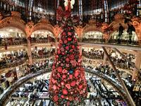 A picture taken on November 20, 2019 shows the Christmas tree during the Christmas windows opening night at the Galeries Lafayette department store in Paris ALAIN JOCARD / AFP