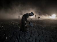 A labourer carries a stone block while working late at the "White Mountain" limestone extraction quarry site near Egypt's southern city of Minya, some 265 kilometres south of the capital, on November 13, 2019. Covered in fine white dust, labourers at the so-called "White Mountain" off Minya toil in shifts amidst brutal conditions with little workplace safety for paltry pay. They handle dangerous machinery with finesse, and shrug off the dangers of a job where a mistake can prove fatal. Khaled DESOUKI / AFP