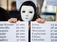 A woman holds a placard enumerating the names of feminicide victims in France in 2019, during a protest to condemn violence against women, on November 23, 2019 in Marseille, southern France. CLEMENT MAHOUDEAU / AFP