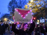 A woman holds a placard with a pasted knicker on it and reading "This is not consent" during a protest to condemn violence against women, on November 23, 2019, in Paris. Alain JOCARD / AFP