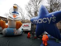 The Aflac Duck and Macys balloon are pictured during the Macy's Thanksgiving Day Parade balloon inflation in New York City on November 27, 2019, offering spectators the chance to see the giant balloons being inflated ahead of tomorrow's Parade. Macy's and NYPD will make a decision tommorow on the fate of the balloons due to high winds in the forecast. TIMOTHY A. CLARY / AFP