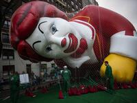 The Ronald McDonald balloon is kept under a net during the inflation process on November 27, 2019 in New York City. Winds could ground the giant balloons, according to city regulations, giant balloons cannot fly with gusts winds above 34 m.p.h. Eduardo Munoz Alvarez/Getty Images/AFP