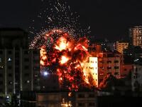 An explosion is pictured among buildings during an Israeli airstike on Gaza City on May 4, 2019. Gaza militants fired a barrage of rockets at Israel, which responded with airstrikes, officials said, as a fragile ceasefire again faltered. Mahmud Hams / AFP