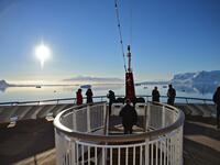 Tourists loot at the sunset from a ship at Chiriguano bay in the South Shetland Islands, Antarctica on November 07, 2019. Johan ORDONEZ / AFP