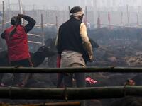 A Hindu devotee slaughters a buffalo as an offering during the Gadhimai Festival in Bariyarpur on December 3, 2019. Thousands of Hindu devotees gathered in southern Nepal for a festival believed to be the world's biggest ritual animal slaughter, despite court orders and calls by animal activists to end the event. The sacrifices take place every five years in Bariyarpur village close to the Indian border, in honour of the Hindu goddess of power. Prakash MATHEMA / AFP