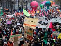 People take part in a demonstration against the pension overhauls, in Paris, on December 5, 2019 as part of a nationwide strike. Trains cancelled, schools closed: France scrambled to make contingency plans on for a huge strike against pension overhauls that poses one of the biggest challenges yet to French President's sweeping reform drive. Thomas SAMSON / AFP