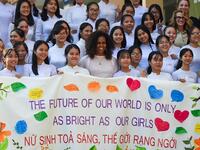 Former US First Lady Michelle Obama (C) poses for picture with Vietnamese students in Can Giuoc district, Long An province on December 9, 2019. Michelle Obama and Julia Roberts visit to promote girls' education in Vietnam. Nhac NGUYEN / AFP