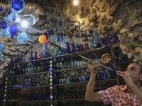 A Palestinian man blows molten glass into a Christmas ornament at his glass factory in the southern West Bank city of Hebron, on December 15, 2019. HAZEM BADER / AFP