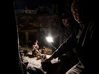 Volunteers Mario Curcetti and Dario Assie prepare figures for the "Presepio of Cavallermaggiore", a 300sqm Christmas Nativity crib in the Oratorio San Michele, are pictured at its 43rd edition on December 20, 2019 in Cavallermaggiore, near Cuneo, Northwestern Italy. The "Presepio" is made by ten volunteers who every year spend 3 months to build a new edition with hundreds of figures. MARCO BERTORELLO / AFP