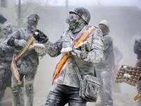 The Els Enfarinats festival takes place every year in Spain and sees two groups of residents cover each other and the entire town white with egg and flour (Twitter)