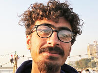 An Iraqi anti-government protestor poses with a distinct hairstyle at Tahrir Square in central Baghdad on December 23, 2019. Since the start of Iraq's anti-government protests on October 1, one thing strikes the eye perhaps above all else -- the unbridled hairstyles young men sport. High quiffs, tight fades and loads of attitude -- it is quite the male beauty pageant. SABAH ARAR / AFP