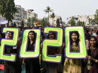 Christians react as they pose holding '2020' numericals signs on the occasion of the New Year celebrations at the Methodist Church Maninagar in Ahmedabad marking New Year, on January 1, 2020. SAM PANTHAKY / AFP