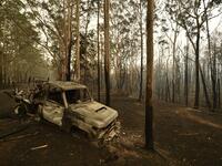 A burnt car is seen in Kangaroo Valley, in Australia's New South Wales state on January 5, 2020. Australians on January 5 counted the cost from a day of catastrophic bushfires that caused "extensive damage" across swathes of the country and took the death toll from the long-running crisis to 24. PETER PARKS / AFP