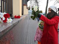 A woman with her daughter lay flowers outside the Canadian Embassy in Kiev on January 8, 2020 in remembrance of the victims of the Ukraine International Airlines Boeing 737-800 crash in the Iranian capital Tehran. A Ukrainian airliner carrying 176 people from seven countries crashed shortly after takeoff from Tehran on January 8, 2020 killing all on board. The vast majority of the passengers on the Boeing 737, which had been flying from Tehran to Kiev for Ukraine International Airlines, were Iranians and Ca