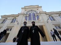 Coptic priests leave after visiting the newly renovated Eliyahu Hanavi synagogue in the northwestern Egyptian city of Alexandria on January 10, 2020, on the day of its inauguration. The synagogue, boasting green and violet stained glass windows and towering marble columns, was built in its current form in 1850 by an Italian architect on top of the original edifice dating back to 1354. Khaled DESOUKI / AFP