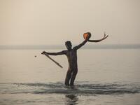 A Hindu devotee takes a holy dip in the Bay of Bengal during the Gangasagar Mela, at Sagar Island, some 150 kilometres south of Kolkata on January 14, 2020. Xavier GALIANA / AFP