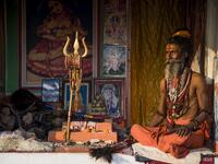 A Hindu Sadhu (holy man) waits to offer blessings to devotees at a temporary camp during the Gangasagar Mela, at Sagar Island, around 150 kilometres south of Kolkata on January 14, 2020. Xavier GALIANA / AFP