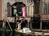 A picture taken on March 2, 2019 shows a woman selling breakfast from a boat in the Makoko waterfront community in a polluted lagoon in Lagos, Africa’s biggest megalopolis in Nigeria. The sprawling community began in the 19th century as a fishing village for immigrants who settled on the water's edge. As more arrived and land became rare, people started to move out onto the water. Over time, Makoko became a floating realm of perhaps a quarter of a million people, although the real number is anyone's guess. 