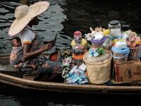 A picture taken on March 2, 2019 shows a woman selling daily items on a boat in the Makoko waterfront community in a polluted lagoon in Lagos, Africa’s biggest megalopolis in Nigeria. The sprawling community began in the 19th century as a fishing village for immigrants who settled on the water's edge. As more arrived and land became rare, people started to move out onto the water. Over time, Makoko became a floating realm of perhaps a quarter of a million people, although the real number is anyone's guess. 