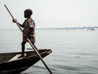 A picture taken on March 2, 2019 shows a boy steering a boat in the Makoko waterfront community in a polluted lagoon in Lagos, Africa’s biggest megalopolis in Nigeria. The sprawling community began in the 19th century as a fishing village for immigrants who settled on the water's edge. As more arrived and land became rare, people started to move out onto the water. Over time, Makoko became a floating realm of perhaps a quarter of a million people, although the real number is anyone's guess. YASUYOSHI CHIBA 