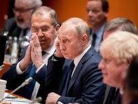 Acting Russian Foreign Minister Sergei Lavrov (L)sits next to Russian President Vladimir Putin at the start of a Peace summit on Libya at the Chancellery in Berlin, on January 19, 2020. World leaders gather in Berlin on January 19, 2020 to make a fresh push for peace in Libya, in a desperate bid to stop the conflict-wracked nation from turning into a "second Syria". AFP