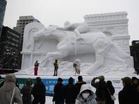 The snow festival, which opened January 31 in the capital of Hokkaido in northern Japan, is a major draw for the region, attracting more than 2.7 million visitors last year. Organisers for this year's festival were forced to truck in an unprecedented amount of extra powder to build their signature sculptures after an unseasonably warm winter.  CHARLY TRIBALLEAU / AFP