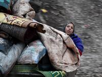 A Syrian girl rides in the back of a truck with belongings and furniture as people displaced from the south of Idlib province travelling in vehicles loaded with furniture and other belongings and fleeing from advancing government forces arrive at a camp for the internally displaced near Dayr Ballut, near the Turkish border in the rebel-held part of Aleppo province in the country's northwest on February 4, 2020. Rami al SAYED / AFP