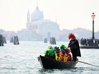 A boat with masked revellers sails on the Grand Canal during the traditional regatta which officially opens the Carnival in Venice, on February 09, 2020. The Venice's carnival takes place until February 25, 2020. Vincenzo PINTO / AFP