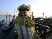 Masked reveller poses in Riva degli Schiavoni during the opening of the Venice Carnival on February 09, 2020. The carnival in Venice takes place until February 25, 2020. Vincenzo PINTO / AFP