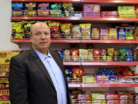 Wael al-Wadiya, chairman of Sarayo Alwadiya company, poses for a photo in front of some of the products his factory produces in Gaza City on February 4, 2020. Israel permits some vegetables and clothing to be sold abroad but not processed food.  EMMANUEL DUNAND / AFP