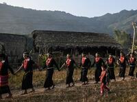 This photo taken on February 7, 2020 shows the end of an overnight ceremony to bless the harvest by Naga tribeswomen in Satpalaw Shaung village, Lahe township in Myanmar's Sagaing region. A haunting refrain pierces the night as the tribeswomen of the Gongwang Bonyo, among the most isolated people in Myanmar, dance around a campfire to bless the harvest ahead. Ye Aung THU / AFP