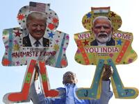 Kite-maker Jagmohan Kanojia (C) poses with kites decorated with the pictures of US President Donald Trump (R) and India's Prime Minister Narendra Modi, in Amritsar on February 23, 2020, ahead of Trump's visit to India. Trump makes his first official visit to India on February 24. NARINDER NANU / AFP