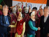Indian school children wearing masks of Indian Prime Minister Narendra Modi and US President Donald Trump pose for a picture while shaking hands at Bright Academy school in Siliguri on February 24, 2020, on the occasion of Trump's first official visit to India. DIPTENDU DUTTA / AFP