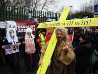 An activist supporting WikiLeaks founder Julian Assange dressed as Jesus with a cross joins other supporters in calling for his freedom outside Woolwich Crown Court in southeast London on February 24, 2020, on the day of the opening of the full hearing into a US request for Assange's extradition. A British court on February 24 starts hearing Washington's extradition request for WikiLeaks founder Julian Assange in a test case of media freedoms in the digital age and the global limits of US justice.  DANIEL L
