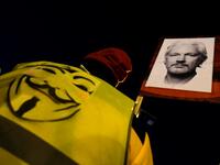 A demonstrator holds a picture of WikiLeaks founder Julian Assange during a supporting protest called by Catalan National Assembly (ANC) under the motto "Journalism is not a crime" in Barcelona on February 24, 2020. A British court today started hearing Washington's extradition request for WikiLeaks founder Julian Assange in a test case of media freedoms in the digital age and the global limits of US justice. LLUIS GENE / AFP