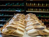 A picture taken at Grishko company shows pointe shoes in the company's Moscow workshop on February 25, 2020. Born in the chaos of the collapse of the Soviet Union, the Grishko family business has emerged among the top makers in the world of dance shoes, notably classic ballet pointe shoes, worn on the world's great stages. Dimitar DILKOFF / AFP