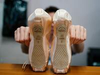 An employee of Grishko company produces pointe shoes in the company's Moscow workshop on February 25, 2020. Born in the chaos of the collapse of the Soviet Union, the Grishko family business has emerged among the top makers in the world of dance shoes, notably classic ballet pointe shoes, worn on the world's great stages. Dimitar DILKOFF / AFP