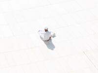 A Muslim worshipper prays near the sacred Kaaba in Mecca's Grand Mosque, Islam's holiest site, on March 7, 2020. Saudi Arabia reopened today the area around the sacred Kaaba, reversing one of a series of measures introduced to combat the coronavirus outbreak. Saudi authorities this week suspended the year-round umrah pilgrimage, during which worshippers circle the Kaaba seven times, and also announced the temporary closure of the area around the cube structure.  Abdel Ghani BASHIR / AFP