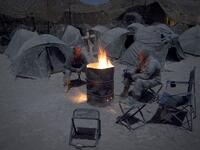 In this file photo taken on December 19, 2010, US soldiers from Alpha Troop 1-75 Cavalry 2nd Brigade 101st Airborne Devision warm themselves around a bonfire at the Sabloghay Camp in Zari district of Kandahar province. American forces have started pulling out of two bases in Afghanistan, a US official said on March 10, 2020 the day peace talks between Kabul and the Taliban were due to start despite widespread violence and a political crisis. The United States is keen to end its longest-ever conflict, and un