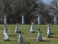 Women dressed as a priestesses take part in the Olympic flame lighting ceremony in ancient Olympia, ahead of Tokyo 2020 Olympic Games on March 12, 2020. LOUISA GOULIAMAKI / AFP