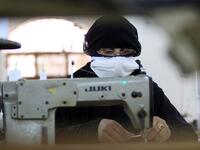 A Yemeni woman makes face masks at a textile factory in the capital Sanaa on March 16, 2020. More than a decade after it shut down, 20 women have brought back to life Yemen's oldest industrial factory to manufacture what could save many lives amid a global pandemic: masks. Mohammed HUWAIS / AFP