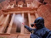 A labourer sprays disinfectant in Jordan's archaeological city of Petra south of the capital Amman on March 17, 2020, to prevent the spread of COVID-19. Khalil MAZRAAWI / afp