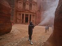 A labourer sprays disinfectant in Jordan's archaeological city of Petra south of the capital Amman on March 17, 2020, to prevent the spread of COVID-19. Khalil MAZRAAWI / afp
