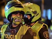 Police officers use face masks as a preventive measure against the spread of the new coronavirus, COVID-19, in Cali, Colombia on March 20, 2020. Colombian authorities announced a mandatory isolation simulation for the extended weekend, from March 21 to 23, as a preventive measure against the spread of the new coronavirus, COVID-19. Luis ROBAYO / AFP