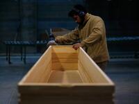An employee polishes a coffin at the Eurocoffin coffins factory in Barcelona on April 3, 2020. More than 900 people died in Spain over the past 24 hours for the second day running, government figures showed, although the rate of new infections and deaths continued to slow. Spain has the world's second-highest death toll after Italy with the virus so far claiming 10,935 lives from 117,710 confirmed cases.  PAU BARRENA / AFP