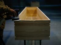 An employee polishes a coffin at the Eurocoffin coffins factory in Barcelona on April 3, 2020. More than 900 people died in Spain over the past 24 hours for the second day running, government figures showed, although the rate of new infections and deaths continued to slow. Spain has the world's second-highest death toll after Italy with the virus so far claiming 10,935 lives from 117,710 confirmed cases.  PAU BARRENA / AFP