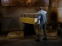 An employee makes a coffin at the Eurocoffin coffins factory in Barcelona on April 3, 2020. More than 900 people died in Spain over the past 24 hours for the second day running, government figures showed, although the rate of new infections and deaths continued to slow. Spain has the world's second-highest death toll after Italy with the virus so far claiming 10,935 lives from 117,710 confirmed cases.  PAU BARRENA / AFP