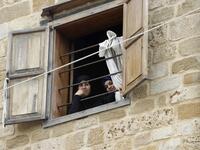 Lebanese women look out of a window during confinement at home due to the COVID-19 pandemic, in the historic part of the southern coastal city of Sidon (Saida), on April 6, 2020. Lebanon's President called on international donors to provide financial assistance to the crisis-hit country as it grapples with a severe economic downturn compounded by the novel coronavirus pandemic. JOSEPH EID / AFP